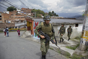 Colombian army soldiers patrol the Loma de Cristobal neighborhood after warring gangs forced dozens of families to flee. Medellin used to be the most dangerous city in the world but officials embarked on innovative projects designed to make life better in tough neighborhoods